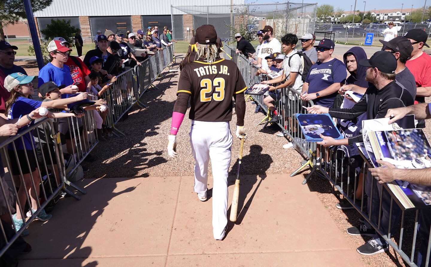 San Diego Padres Fernando Tatis Jr. walks though a group of fans during a spring training practice on Feb. 19, 2020.