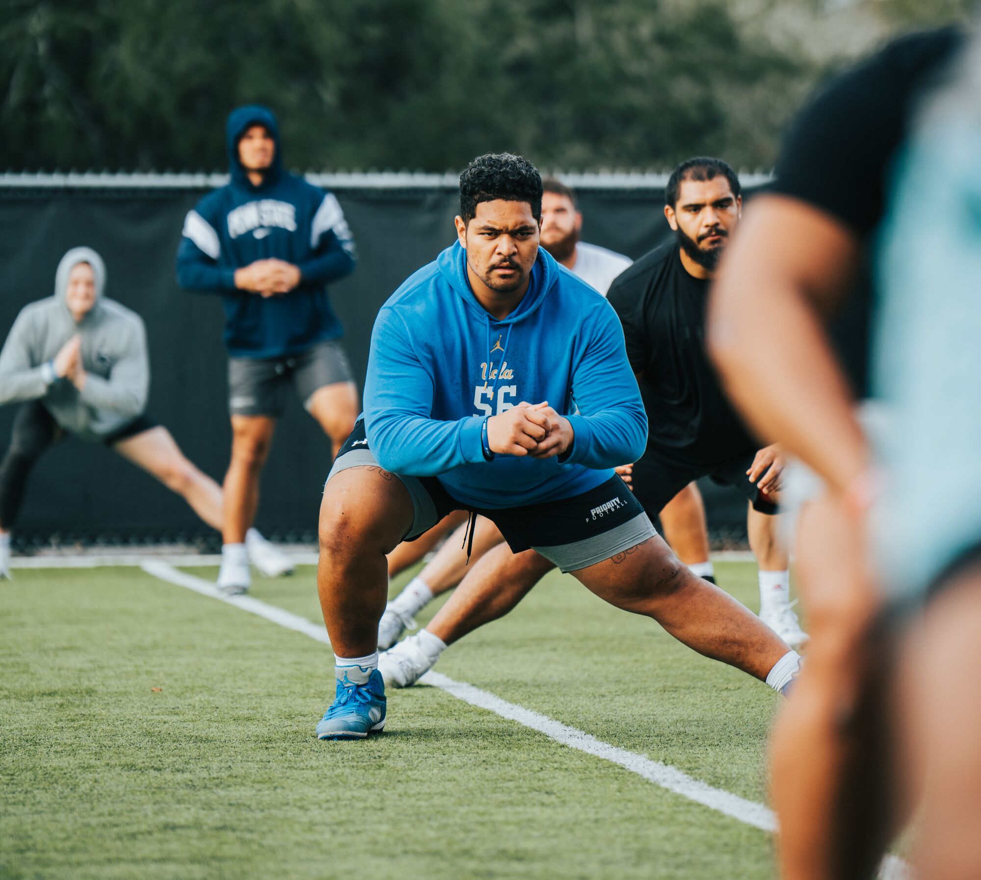 Atonio Mafi stretches during a pre-NFL draft workout in Florida.