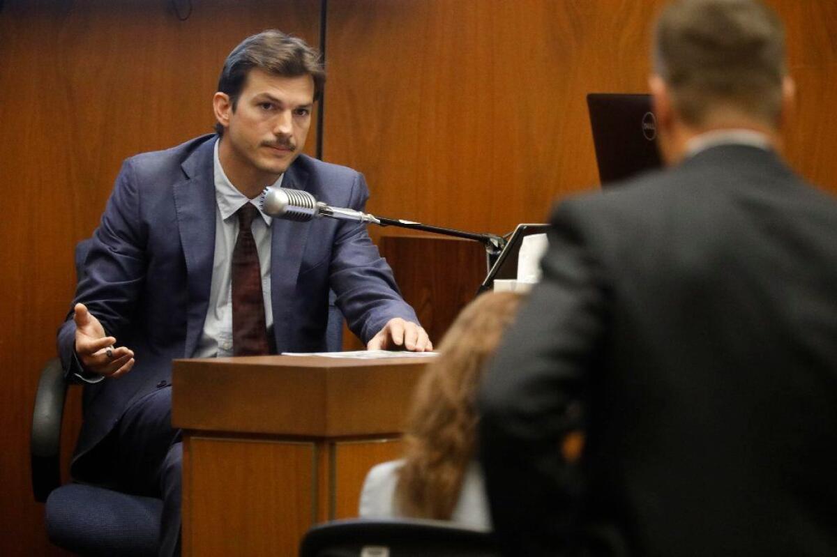 Ashton Kutcher, left, answers questions from prosecuting attorney Daniel Akemon, right, as he testifies in the murder trial of Michael Gargiulo.