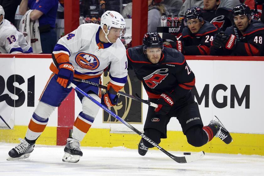 New York Islanders' Bo Horvat (14) collides with Carolina Hurricanes' Brett Pesce (22) during the first period in Game 2 of an NHL hockey Stanley Cup first-round playoff series in Raleigh, N.C., Monday, April 22, 2024. (AP Photo/Karl B DeBlaker)