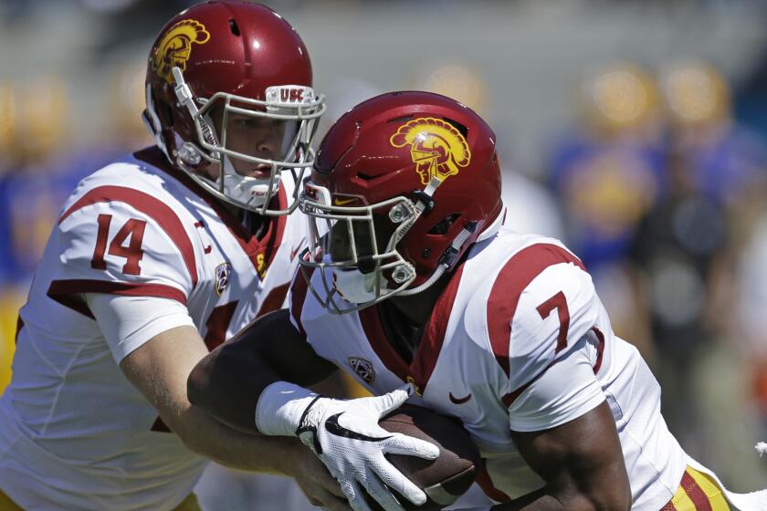 Southern California quarterback Sam Darnold, left, hands off to Stephen Carr (7) California's during the first half of an NCAA college football game Saturday, Sept. 23, 2017, in Berkeley, Calif. (AP Photo/Ben Margot)