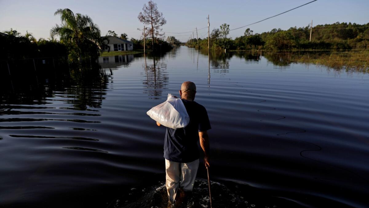 Jean Chatelier leaves his house Sept. 12 after retrieving his uniform so he can return to his supermarket job: "I want to go back to work. I want to help."