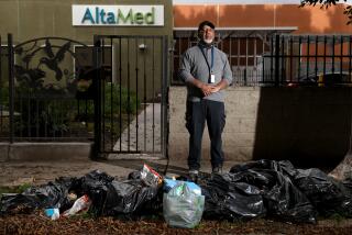 LOS ANGELES, CA - MAY 04: William Taylor, 70, stands in front of bags of trash along Beach St off of Century Ave in Watts on Thursday, May 4, 2023 in Los Angeles, CA. Illegal dumping plagues many Los Angeles neighborhoods. The blight drives down property values and leaves the overwhelmingly Black and Latino residents fuming. (Gary Coronado / Los Angeles Times)