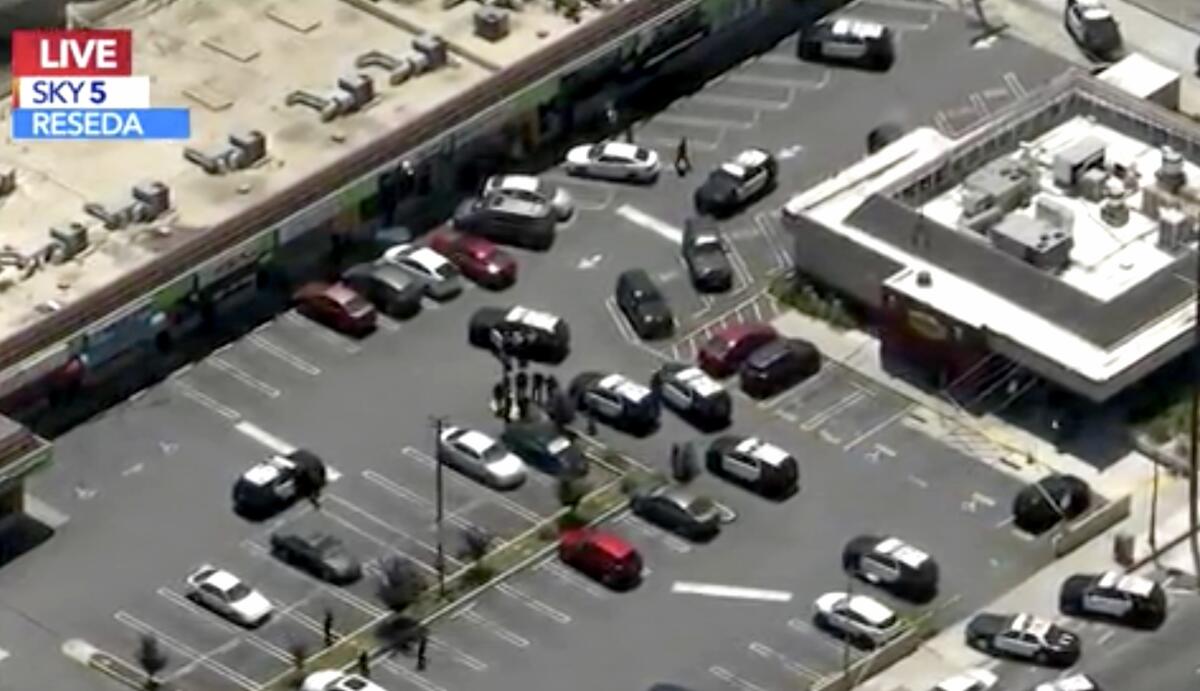 An aerial image from TV of a parking lot with police cars