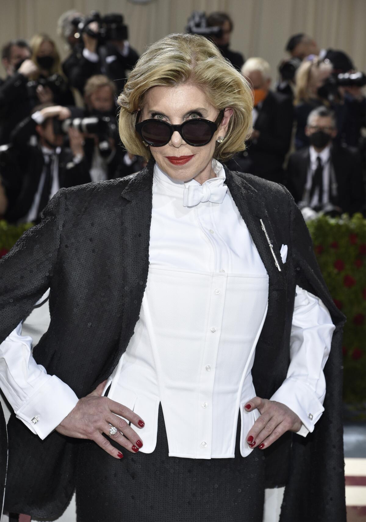 A blond woman wears sunglasses and a tuxedo at the Met Gala