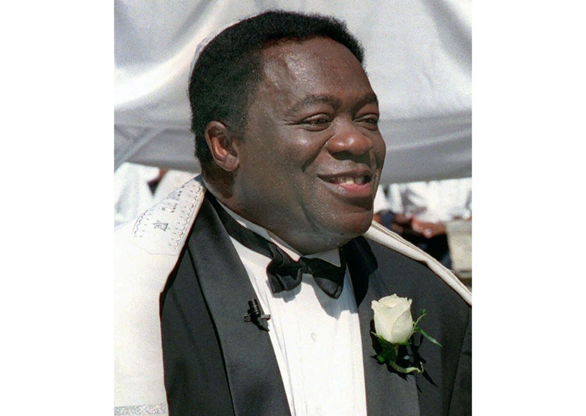 Yaphet Kotto smiles in a tuxedo.