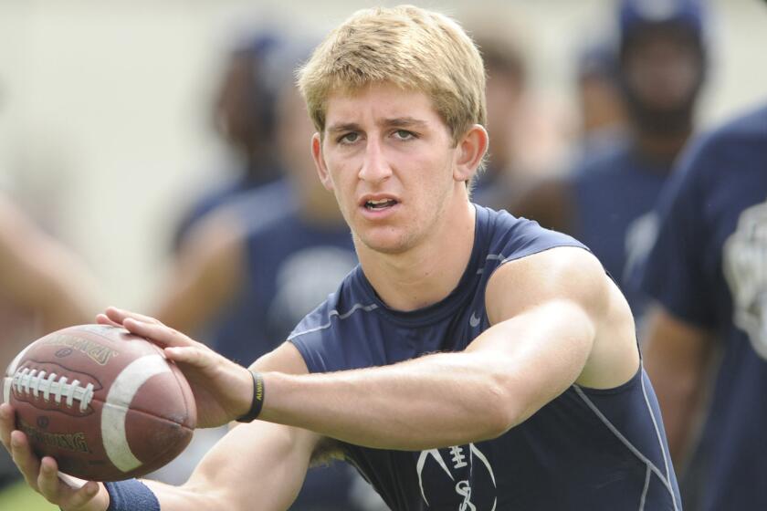 St. John Bosco quarterback Josh Rosen takes a snap during a 2013 summer passing tournament. Rosen signed a scholarship contract with UCLA on Monday.