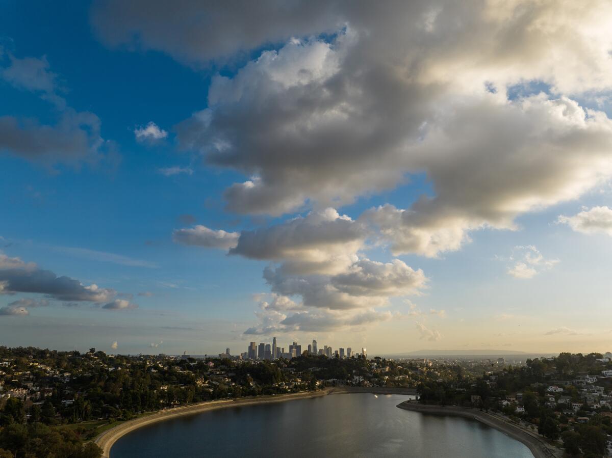 Downtown Los Angeles skyline under clouds as seen from the Silver Lake Reservoir.