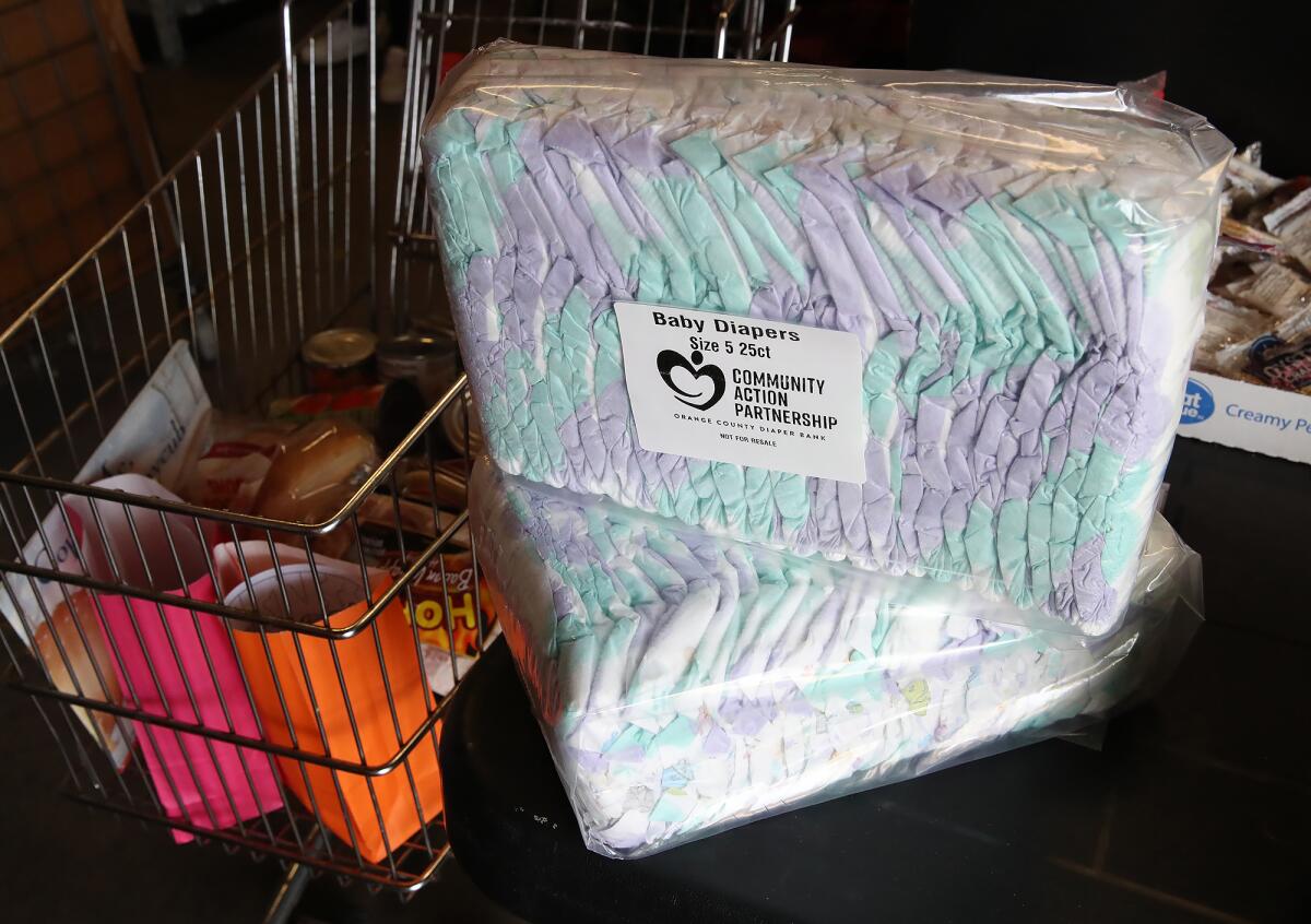 Diapers are prepared to go with a client at the Families Forward food pantry in Irvine.