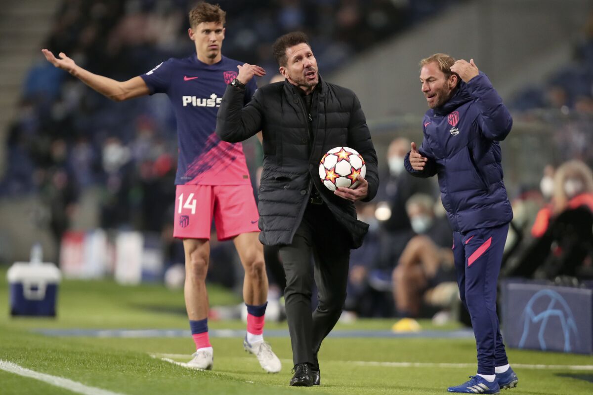 Atletico Madrid head coach Diego Simeone, center, gestures during the Champions League Group B soccer match between FC Porto and Atletico Madrid at the Dragao stadium in Porto, Portugal, Tuesday, Dec. 7, 2021. (AP Photo/Luis Vieira)