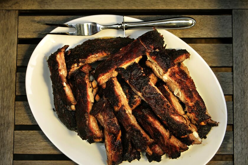 Pork ribs are rubbed down with spices then smoked until the meat falls off the bone. Recipe: Ribs.