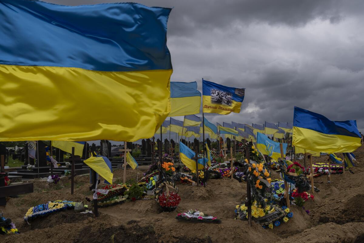ARCHIVO - Banderas ucranianas ondean sobre tumbas de soldados caídos en un cementerio en Járkiv, en el este de Ucrania