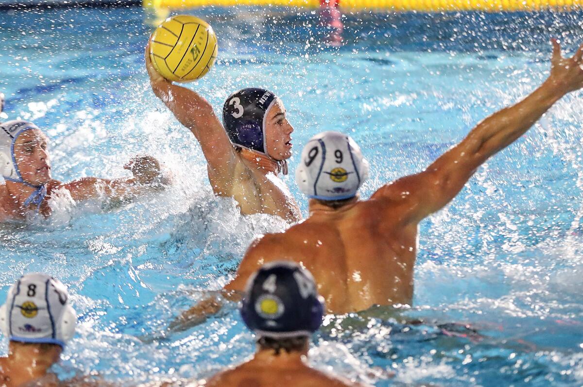 Newport Harbor's Trey Smith (3) shoots during the Battle of the Bay water polo game against Corona del Mar on Friday.