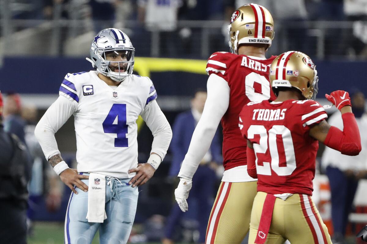 Dallas Cowboys quarterback Dak Prescott (4) reacts next to San Francisco 49ers defensive end Arik Armstead, middle, and cornerback Ambry Thomas (20) after the final play of an NFL wild-card playoff football game in Arlington, Texas, Sunday, Jan. 16, 2022. (AP Photo/Roger Steinman)