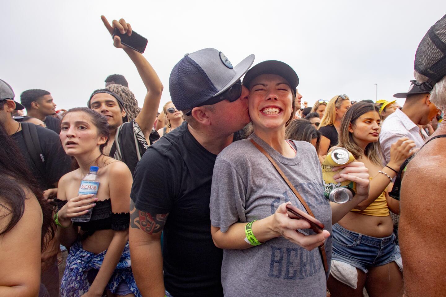 Audience members wait for Snoop Dogg's appearance Sunday at the Nood Beach festival at SeaLegs by the Sea at Bolsa Chica State Beach.