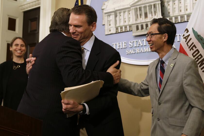 State Sen. Bob Hertzberg, D-Van Nuys, left, and Assemblyman Ed Chau, D-Arcadia, right, celebrate with Alastair Mactaggart, center, after the Legislature approved their data privacy bill Thursday, June 28, 2018, in Sacramento, Calif. Mactaggert removed a similar initiative he sponsored from the November ballot because the bill was passed. (AP Photo/Rich Pedroncelli)