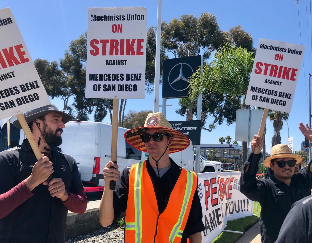 Auto technicians picket in front of the Mercedes Benz of San Diego dealership in Kearny Mesa.  