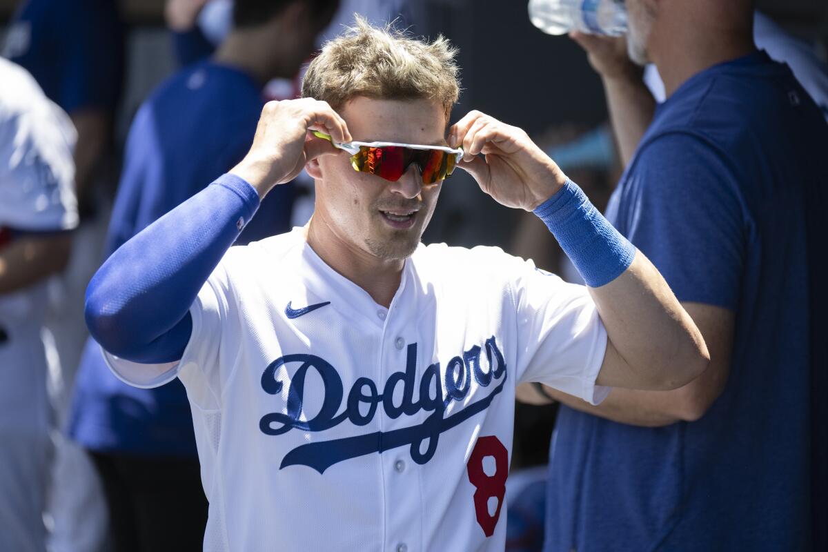 Kiké Hernández adjusts his sunglasses in the Dodgers' dugout before a game against the Toronto Blue Jays on July 26, 2023.