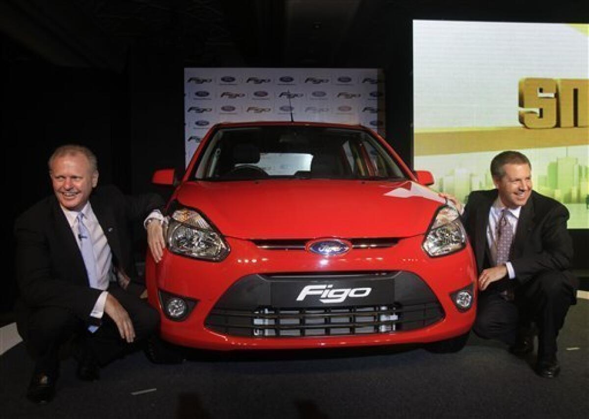 Ford Vice President and President Asia Pacific and Africa Joe Hinrichs, right, and President and Managing Director Ford India Michael Boneham, left, pose with the newly launched Figo car in New Delhi, India, Tuesday, March 9, 2010. The petrol version of the Figo will cost USD $7289 and the diesel version USD$9331 onwards. (AP Photo/Manish Swarup)