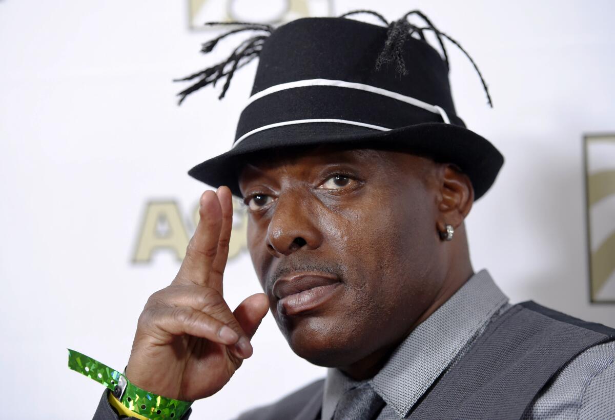 Rapper Coolio gestures with his hand next to his face