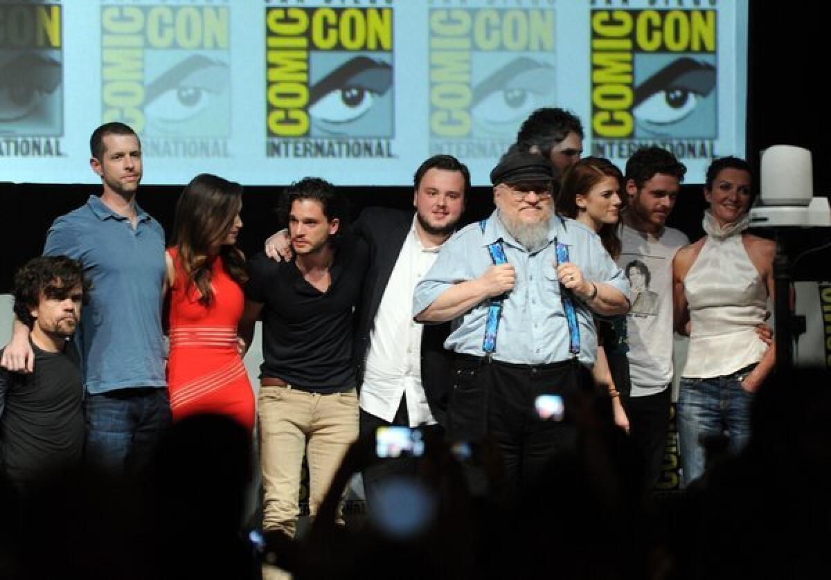 George R.R. Martin, in suspenders, with the cast and writer-producers of "Game of Thrones" at 2013's Comic-Con.