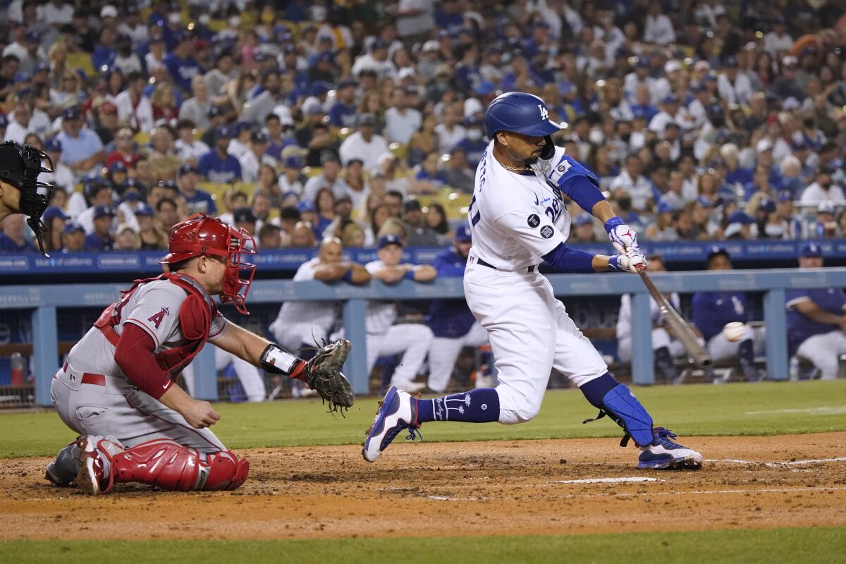 The Dodgers' Mookie Betts drives in a run with a fourth-inning single Aug. 6, 2021.