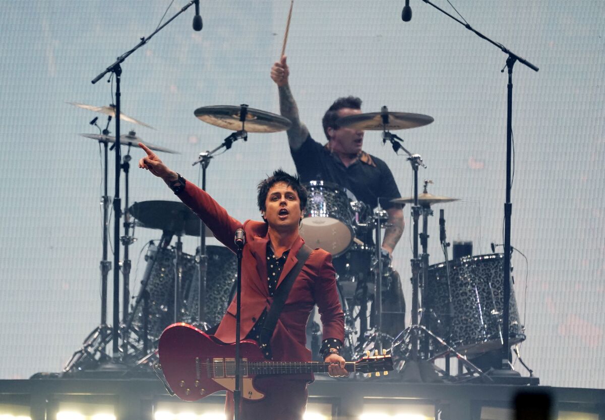 Billie Joe Armstrong, center, and Tre' Cool, top, of Green Day perform on day three of the Bud Light Super Bowl Music Fest, Saturday, Feb. 12, 2022, at Crypto.com Arena in Los Angeles. (AP Photo/Chris Pizzello)