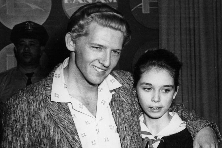 Seen at a London press conference on May 24, 1958 are Jerry Lee Lewis, 22, and his cousin, Myra Brown, 13.