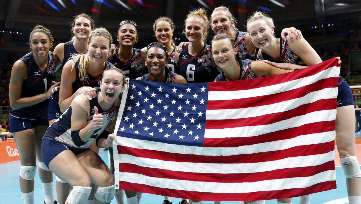 U.S. players celebrate after winning the bronze medal in women's volleyball on Saturday.