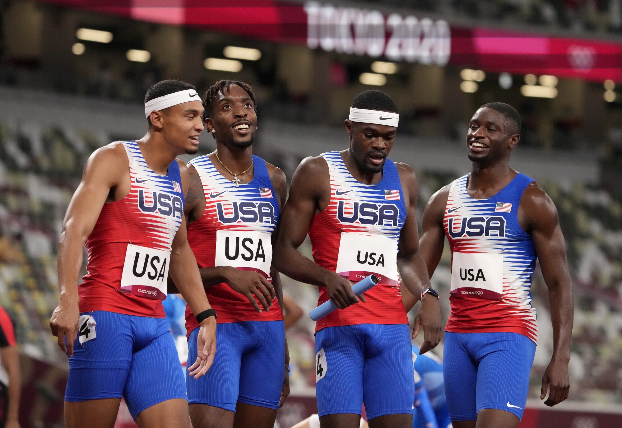 Michael Norman, left, and his American partners celebrate after winning the gold medal in the men's 4 × 400-meter relay.