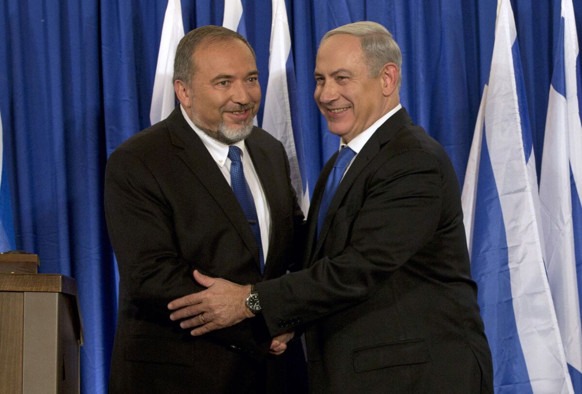 Israeli Prime Minister Benjamin Netanyahu, right, shakes hands with Yisrael Beiteinu party leader and former Defense Minister Avigdor Lieberman in Jerusalem on Oct. 25, 2012. After forcing an unprecedented second Israeli election of the year by refusing to join the government of Netanyahu, his onetime ally, the maverick Lieberman is now poised to be the kingmaker in the do-over vote on Sept. 17, 2019. Neither Netanyahu nor his chief challenger Benny Gantz appears able to form a coalition without Lieberman.