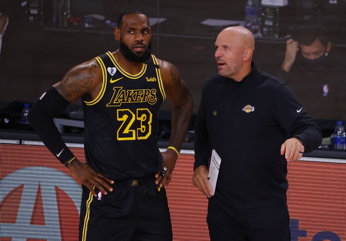 Lakers assistant coach Jason Kidd talks to LeBron James on the sideline.