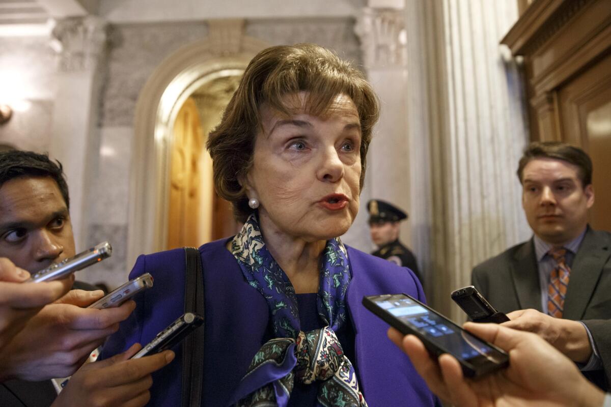 Sen. Dianne Feinstein talks to reporters as she leaves the Senate chamber.