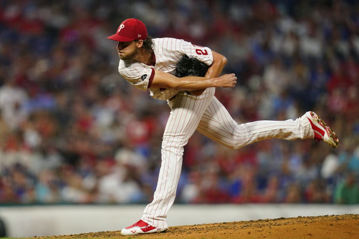 Philadelphia Phillies' Aaron Nola follows through on a pitch during the fourth inning of a baseball game against the Los Angeles Dodgers, Tuesday, Aug. 10, 2021, in Philadelphia. (AP Photo/Matt Slocum)