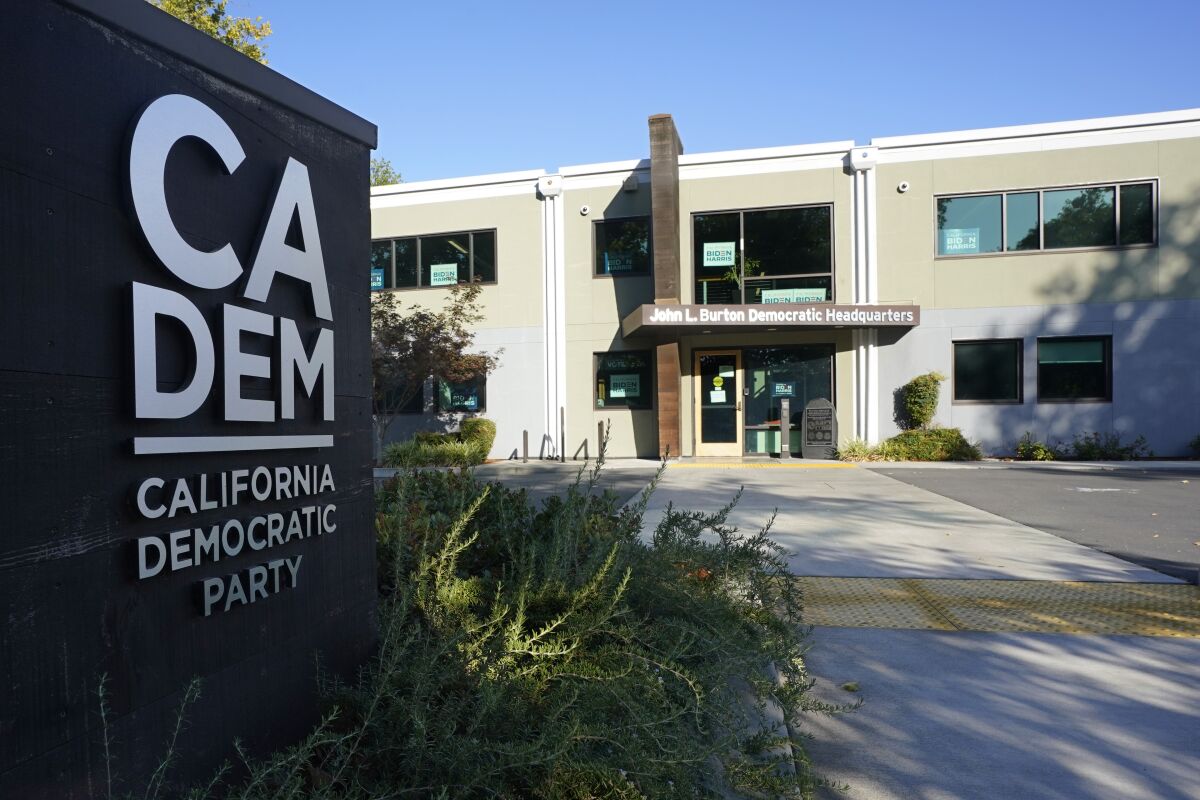 A two-story building is fronted by a sign that says "CA DEM, California Democratic Party."