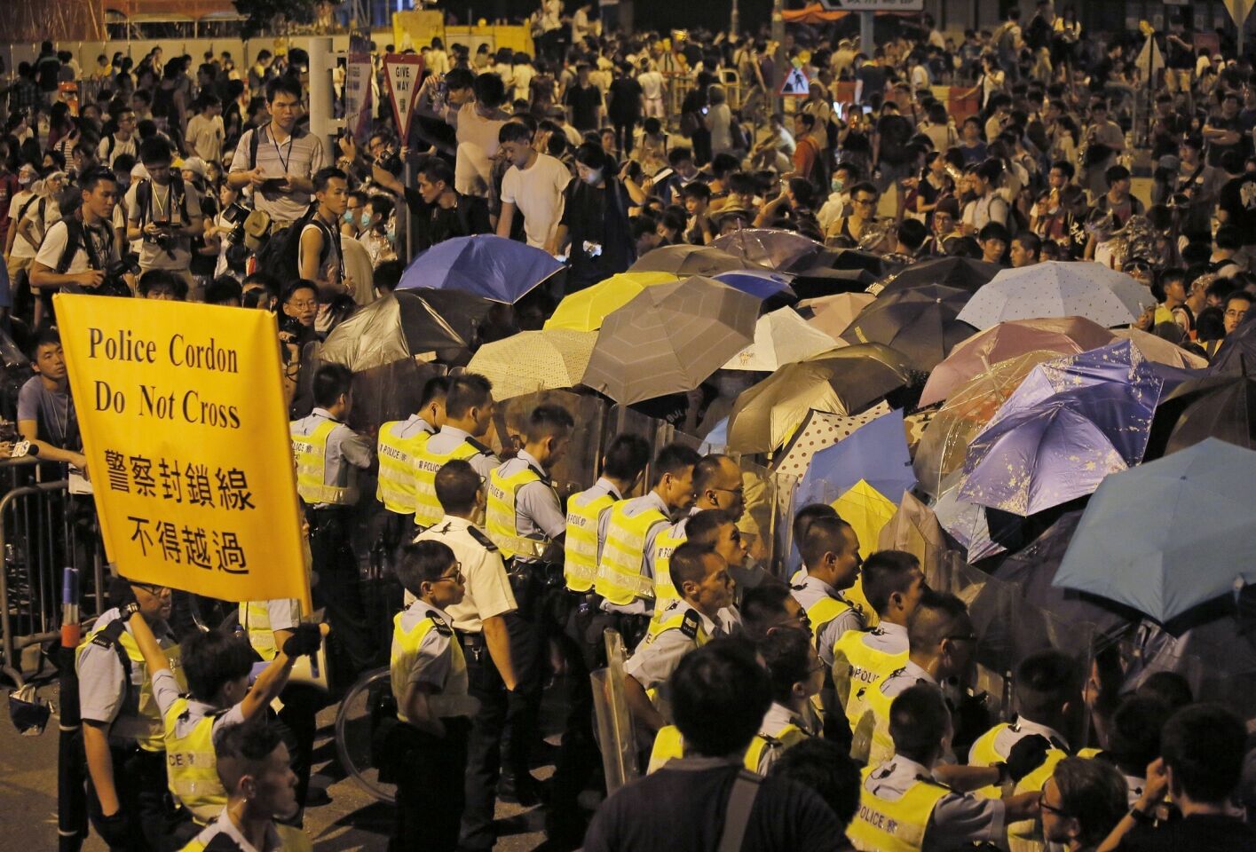 Pro-democracy protesters confront police in Hong Kong early Saturday.