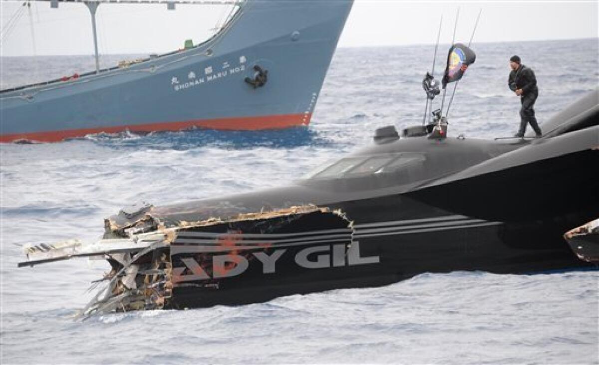 This photo provided by the Sea Shepherd Conservation Society shows the sheared off bow of the Ady Gil, a high-tech speed boat that resembles a stealth bomber after a collision with a Japanese whaling ship in the frigid waters of Antarctica on Wednesday Jan. 6, 2010. The conservation group said its vessel had its bow sheared off after it was hit by the Shonan Maru, background, near Commonwealth Bay. The clash was the most serious in the past several years, during which the Sea Shepherd has sent vessels into far-southern waters to try to harass the Japanese fleet into ceasing its annual whale hunt. Crew member Laurens De Groot is seen on top of the vessel. (AP Photo/Sea Shepherd Conservation Society, JoAnne McArthur) NO SALES MANDATORY CREDIT
