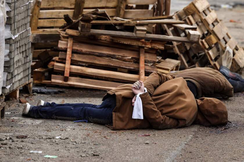 EDITORS NOTE: Graphic content / TOPSHOT - The body of a man, with his wrists tied behind his back, lies on a street in Bucha, just northwest of the capital Kyiv on April 2, 2022. - The bodies of at least 20 men in civilian clothes were found lying in a single street on April 2, 2022, after Ukrainian forces retook the town of Bucha near Kyiv from Russian troops, AFP journalists said. Russian forces withdrew from several towns near Kyiv in recent days after Moscow's bid to encircle the capital failed, with Ukraine declaring that Bucha had been "liberated". (Photo by RONALDO SCHEMIDT / AFP) (Photo by RONALDO SCHEMIDT/AFP via Getty Images)