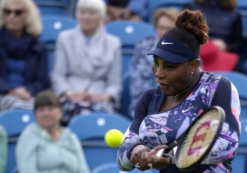 Serena Williams scores a return during their doubles match at Eastbourne on Tuesday.