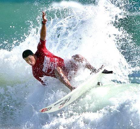 Bobby Martinez gets his fins out of the water during a slashing turn in the 1999 U.S. Open of Surfing at the Huntington Beach Pier. Martinez competed in the junior division, placing second, and advanced to the next round.