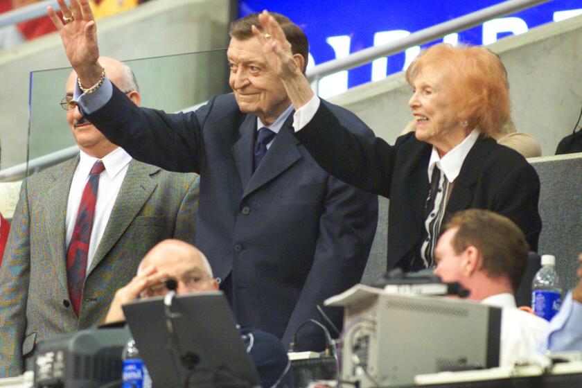 Lakers announcer Chick Hearn and his wife, Marge, at Staples Center in 2002.