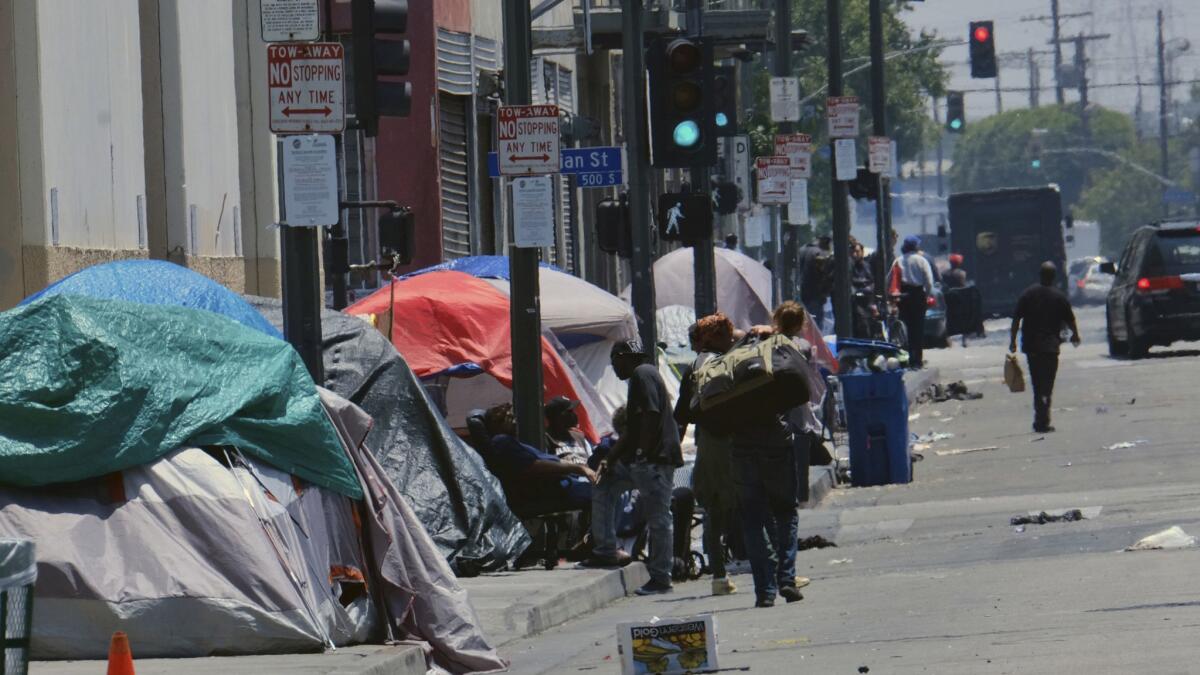 Homeless people have set up tent encampments on streets throughout Los Angeles.