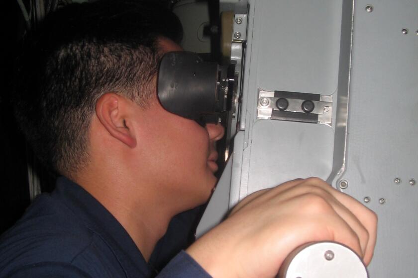 Hany Hong operating the periscope on USS TOPEKA in 2014