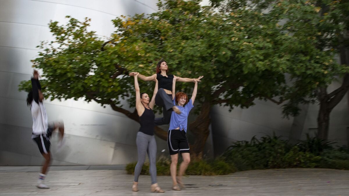 Dancers with Mixed eMotion Theatrix rehearse for their Moves After Dark performance in the garden of Disney Hall.
