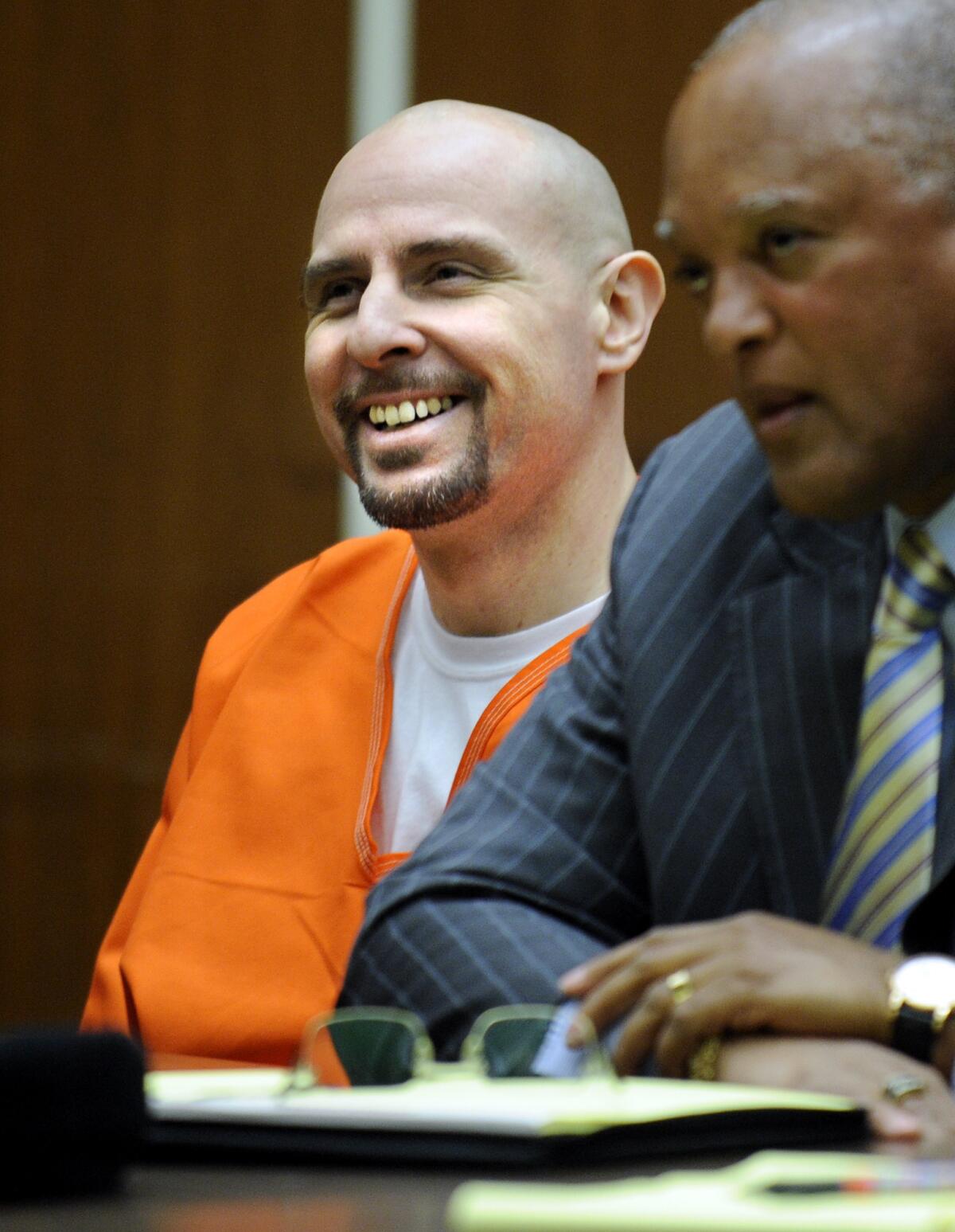 Gang member and convicted murderer Timothy McGhee laughs during sentencing as his attorney Franklin Peters Jr. listens to the judge. McGhee was sentenced to death after murdering three people.