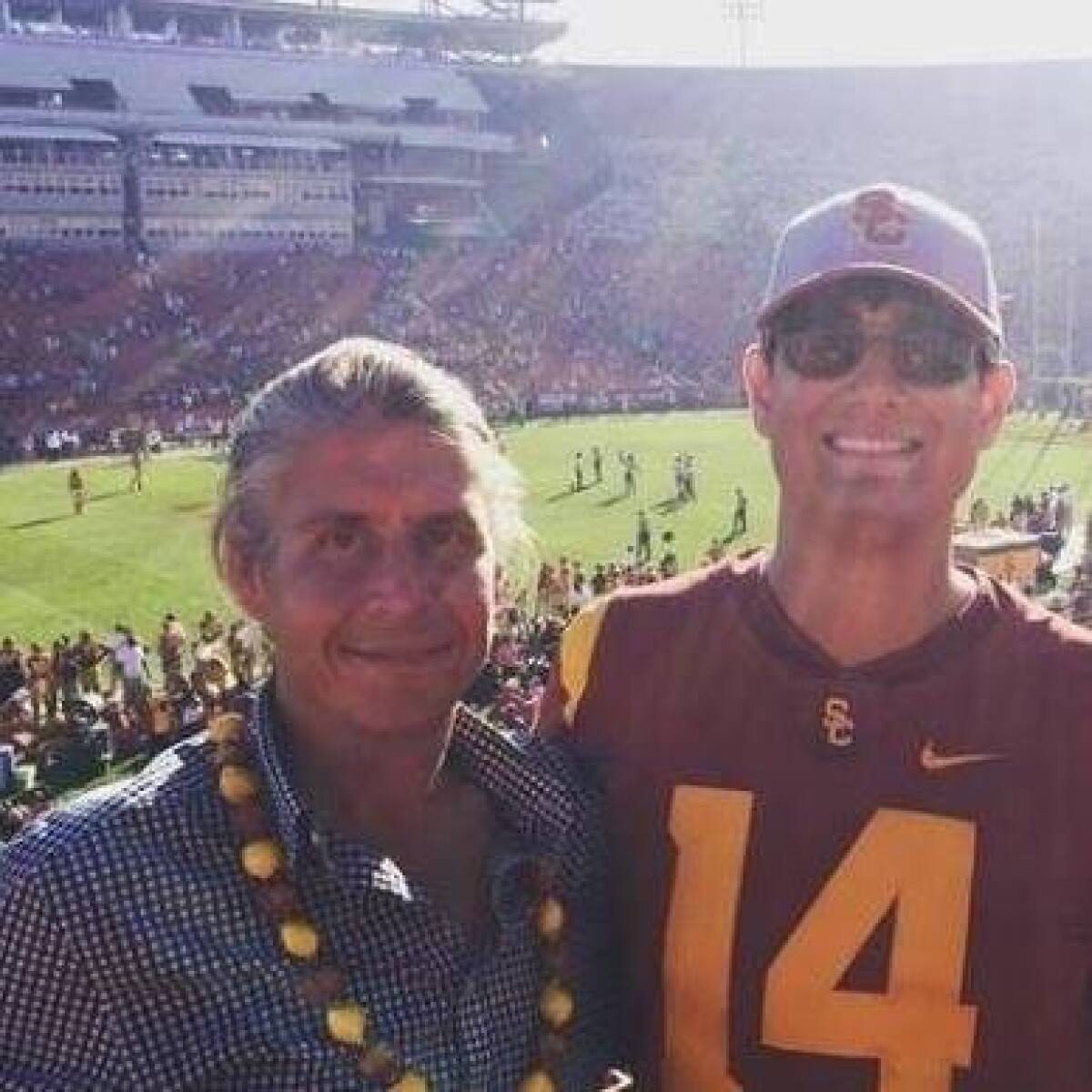 USC fan Vince Skolny, left, at a USC football game.