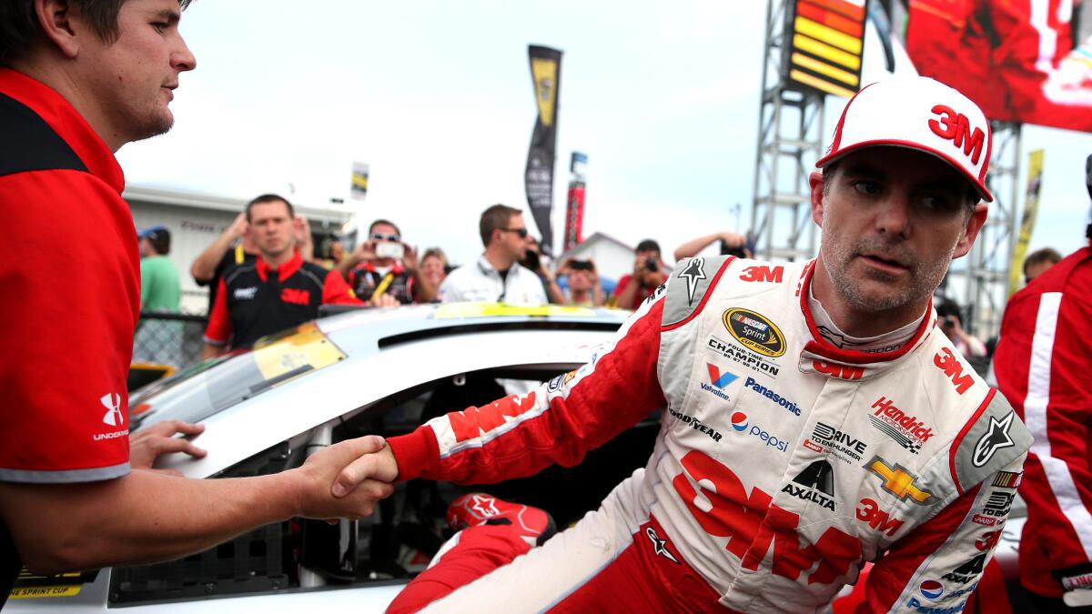 NASCAR driver Jeff Gordon is congratulated Saturday as he climbs out of his car after winning the pole position for the Sprint Cup race at Talladega Superspeedway.