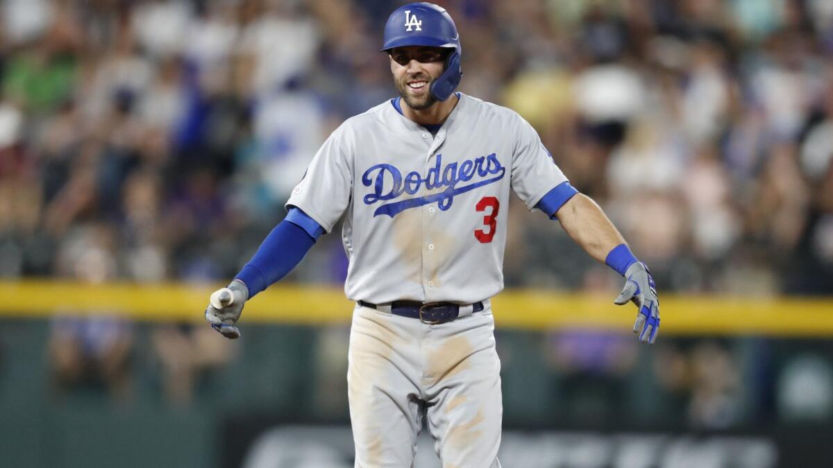Dodgers' Chris Taylor celebrates after his single drove in the go-ahead run off Colorado Rockies relief pitcher Wade Davis during the ninth inning on Thursday in Denver. The Dodgers won 12-8.
