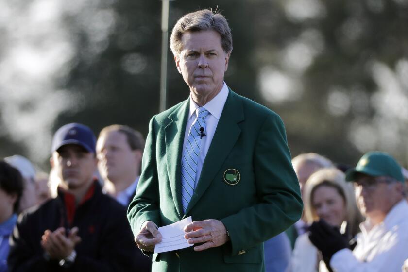 FILE - In this April 5, 2018, file photo, Augusta National Golf Club Chairman Fred Ridley watches the honorary first tee shots before the first round at the Masters golf tournament in Augusta, Ga. Augusta National decided Friday, March 13, 2020, to postpone the Masters because of the spread of the coronavirus. Club chairman Fred Ridley says he hopes postponing the event puts Augusta National in the best position to host the Masters and its other two events at some later date. Ridley did not say when it would be held.(AP Photo/David J. Phillip, File)