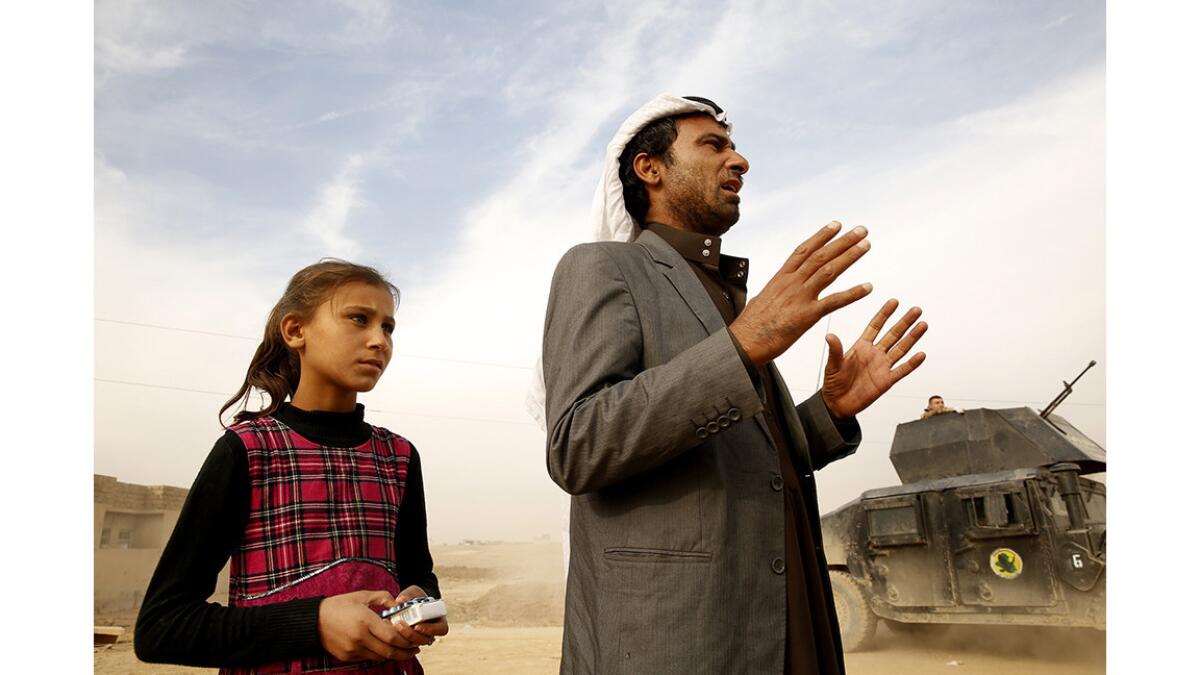 Faraj Saraj and his daughter Nasreen, 10, plan to go back to their homes after getting medicine at an Iraqi army field clinic.